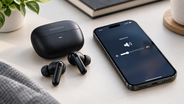 Wireless earbuds and smartphone illustrating how to fix low earbud volume