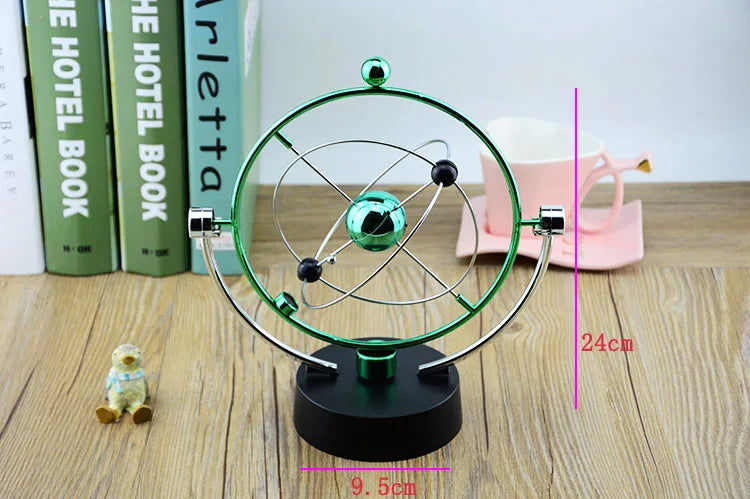 Orbital model on a wooden surface with books and a pink object in the background