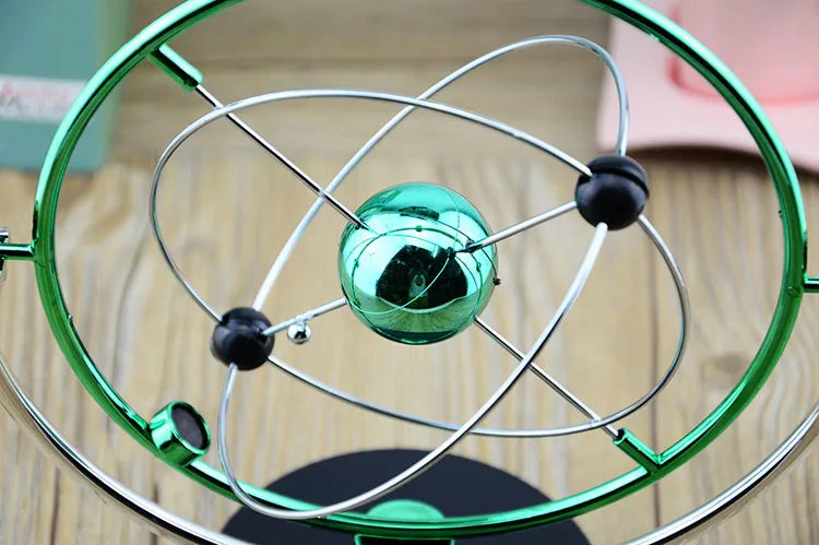 Green metal atom model on a wooden surface
