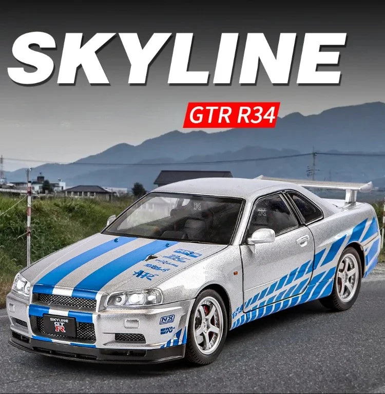 A silver Nissan Skyline GTR R34 model car with blue and white racing stripes, shown outdoors on a road with mountains in the background. Large text overlays read 'SKYLINE' and 'GTR R34'.